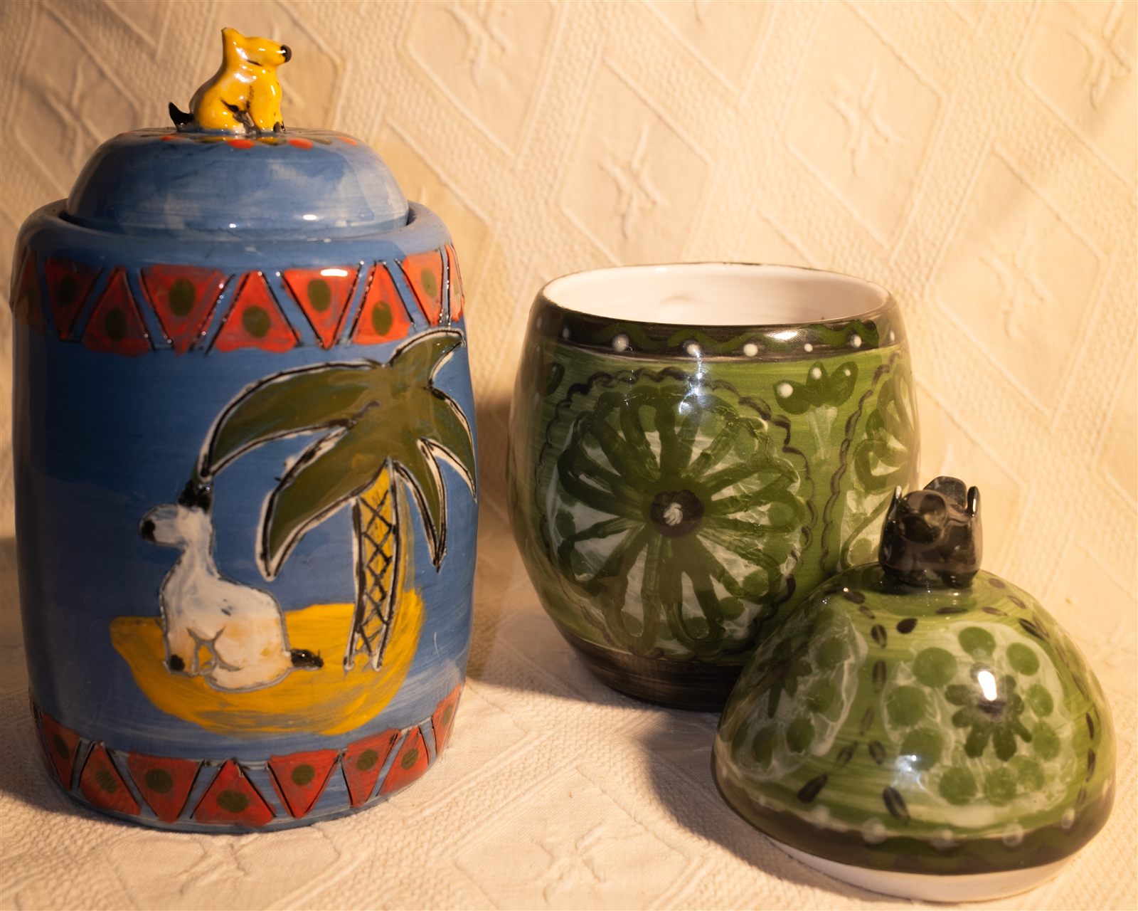 Blue palm tree canister with dog finial