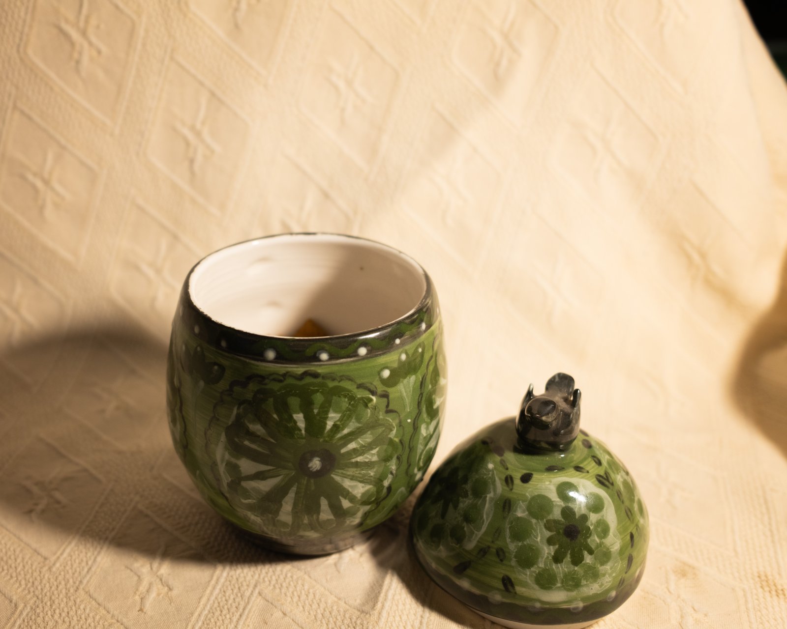 Green floral canister with lizard finial, open