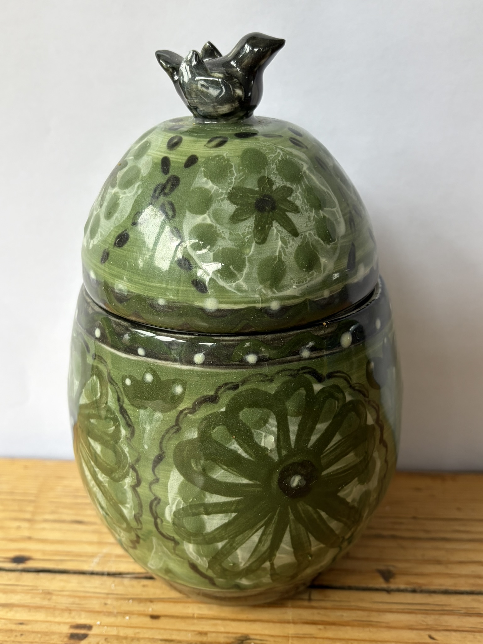 Green slip decorated bird lid canister